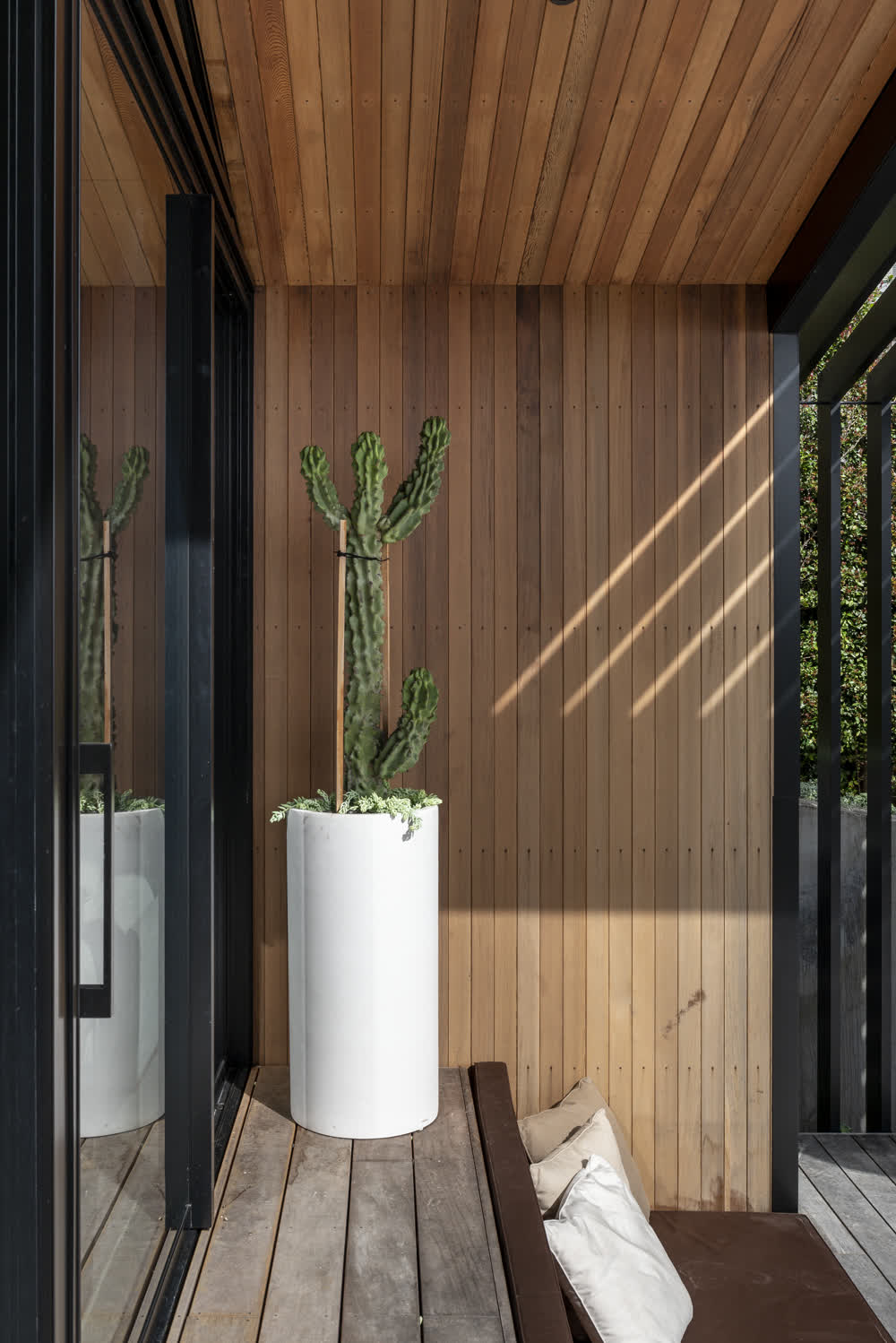 Decked area and wooden overhang above built-in steps with seating